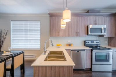 Modern, bright, clean, kitchen interior with stainless steel appliances in a luxury house