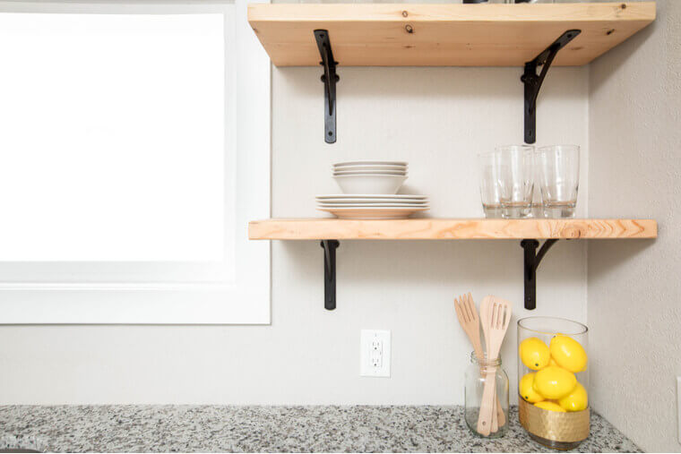 Wooden floating shelves in a modern kitchen space Wooden floating shelves in a modern kitchen space