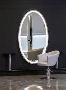 A white mirror with lighting 