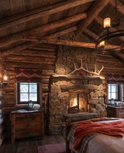 A stone bedroom fireplace surrounded by wood structure