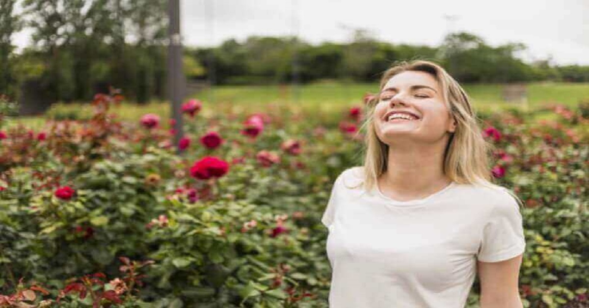 Joyful woman standing in garden