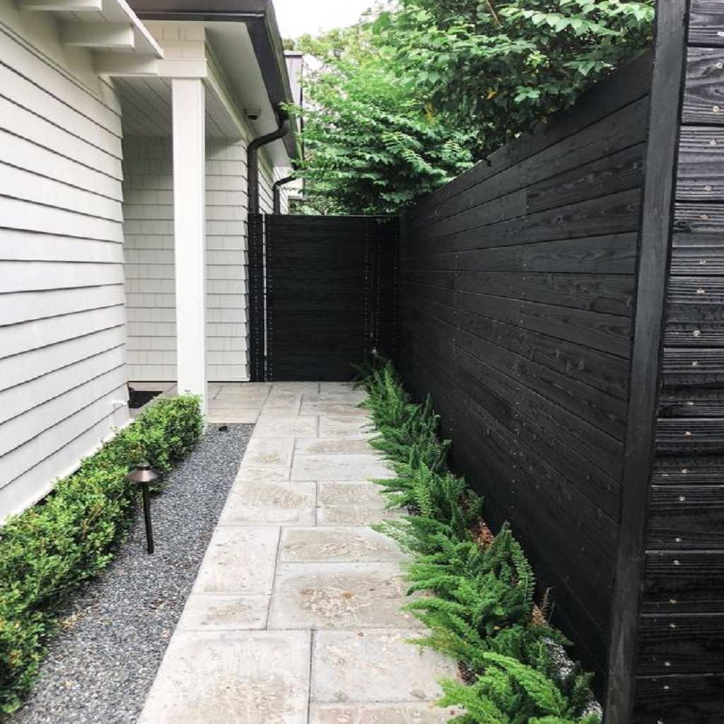 rustic tile walkway with plants on the sides