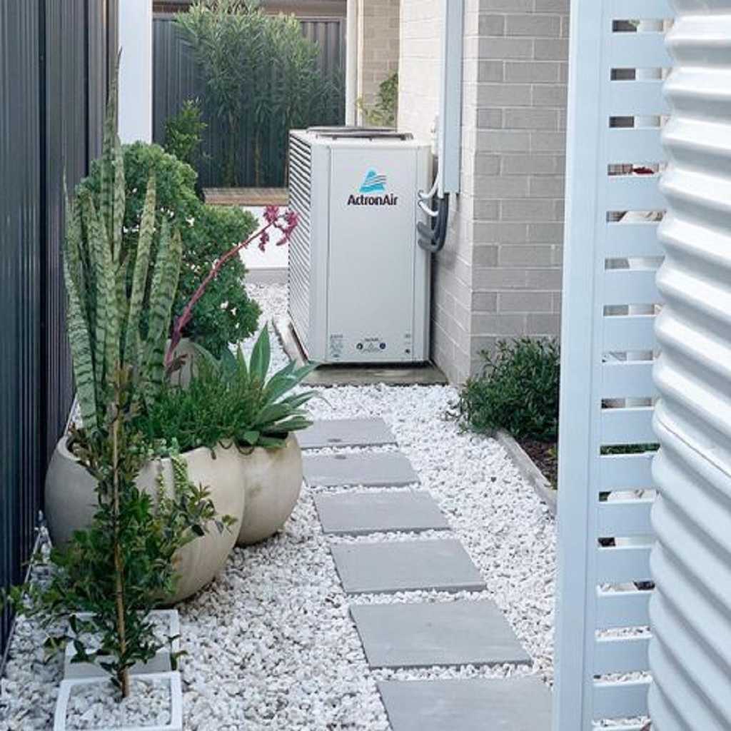 Side garden with potted snake plants and marble pebbles Side garden with potted snake plants and marble pebbles