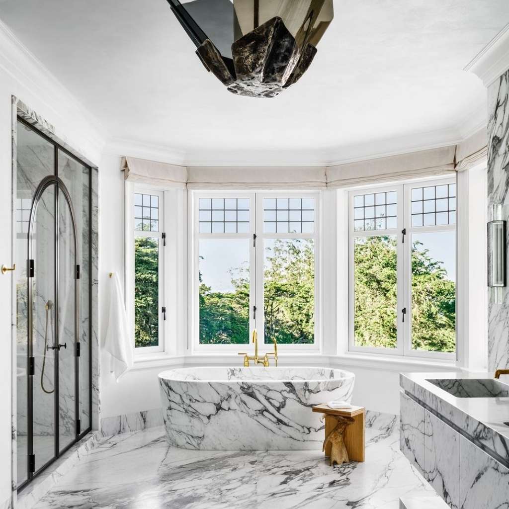 A luxurious master bathroom with fully marbled aesthetics A luxurious master bathroom with fully marbled aesthetics