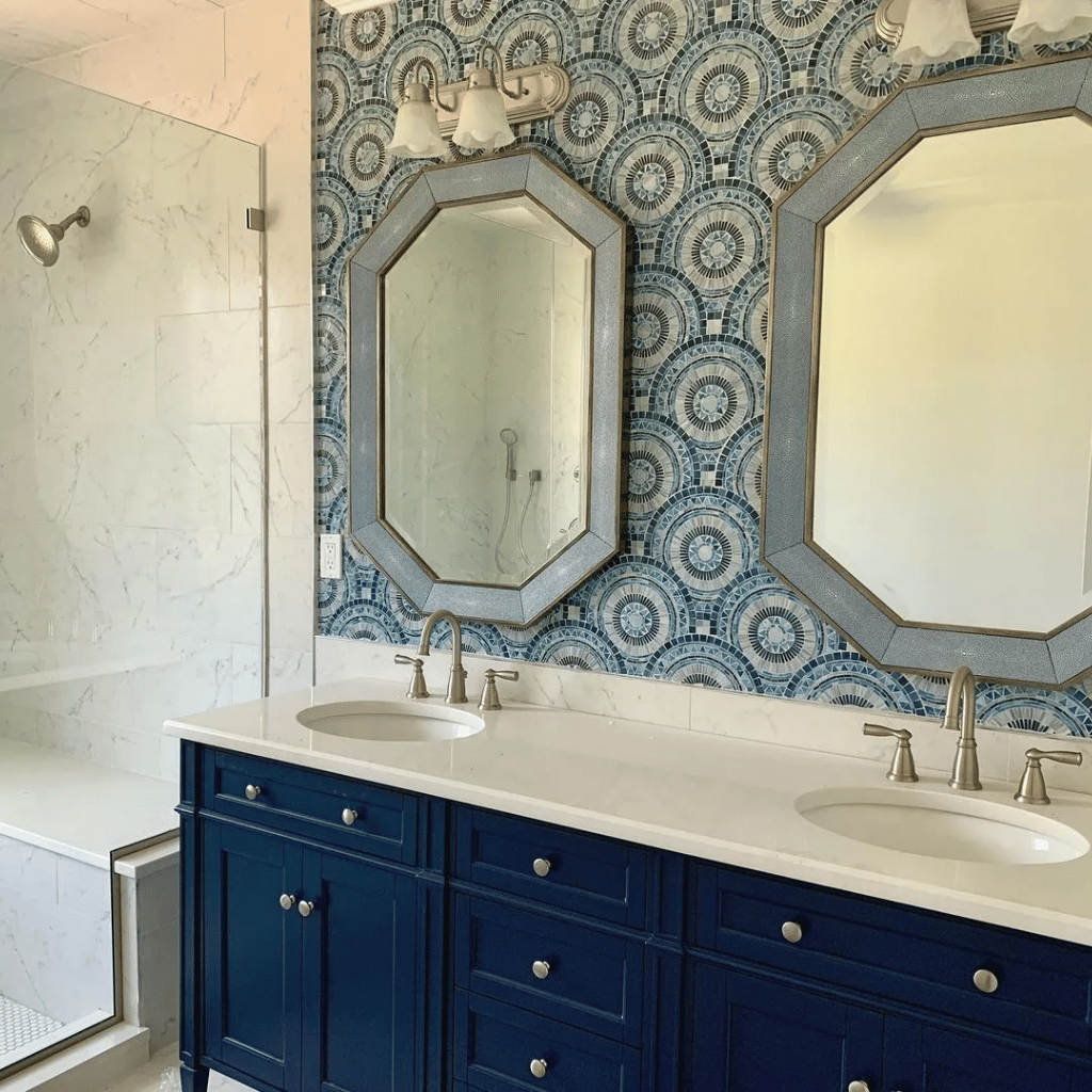 A bathroom accented with navy blue cabinets