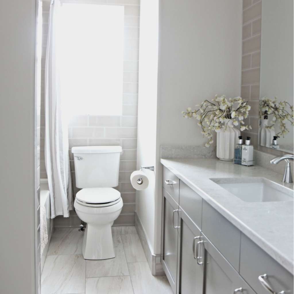 A bathroom with grey-painted cabinets