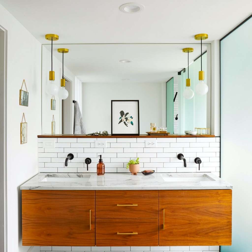 A bathroom with overhanging light fixtures A bathroom with overhanging light fixtures