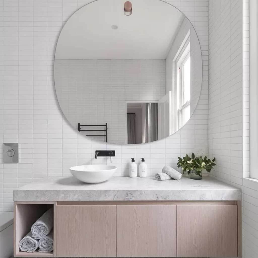 A floating bathroom affixed in a tiled wall