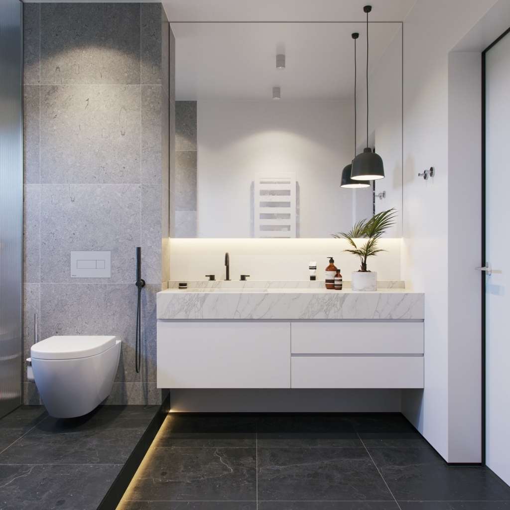 A grey themed bathroom with marble tops