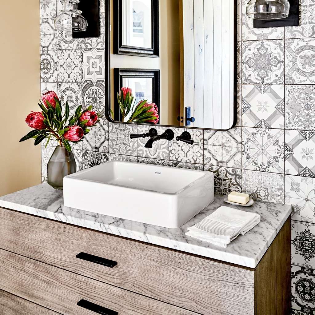 A vanity bathroom with graphic backsplash A vanity bathroom with graphic backsplash