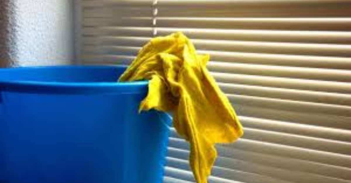 A bowl and a towel for cleaning Venetian blinds