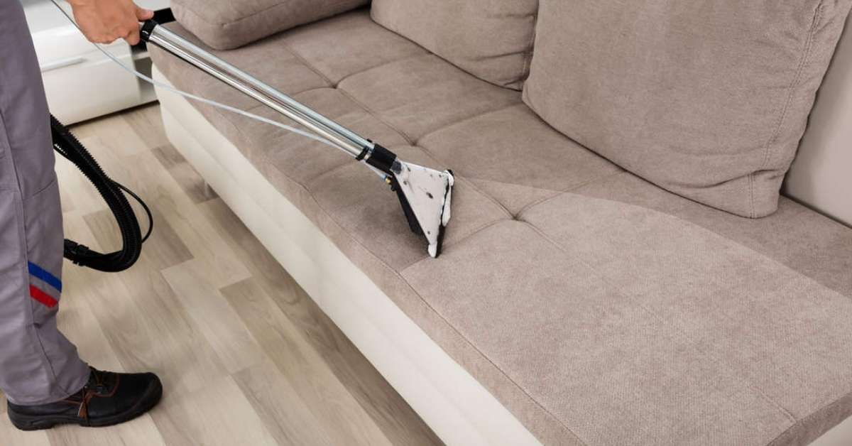 a man cleaning a suede couch with a carpet cleaner a man cleaning a suede couch with a carpet cleaner