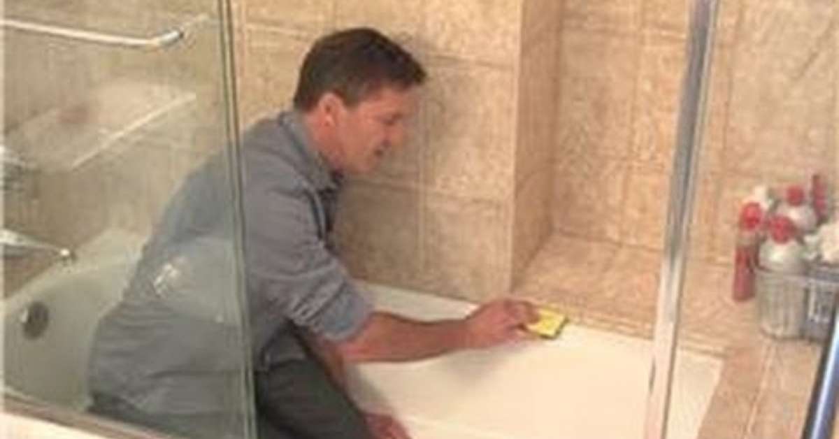 a man cleaning rubber seal on shower screen