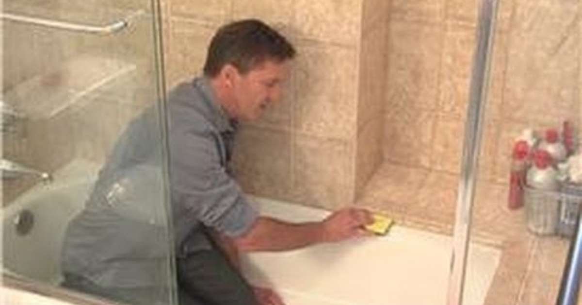 a man cleaning rubber seal on shower screen a man cleaning rubber seal on shower screen