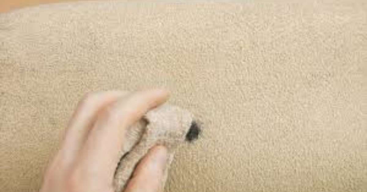 A man removing: Image showing how to remove ink stains from suede couch