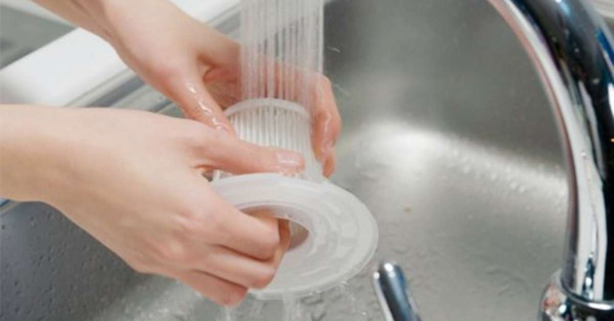 Image of cleaning vacuum filter with water