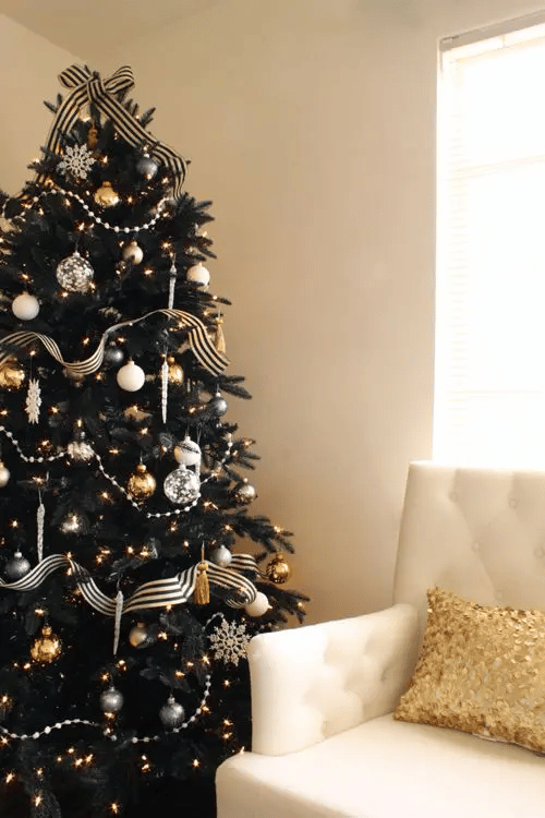 This black Christmas tree features minimal use of rose gold ornaments