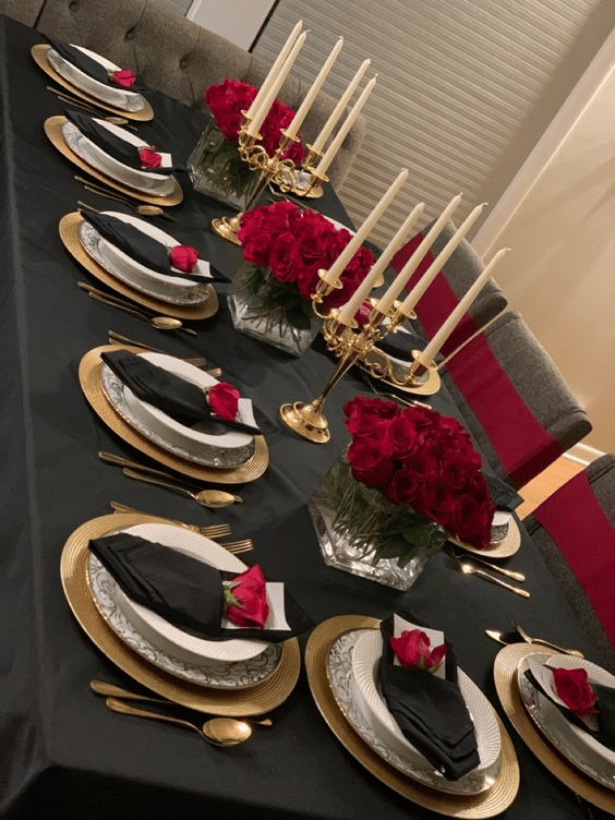 Black-and-gold Christmas table with touch of red ornaments