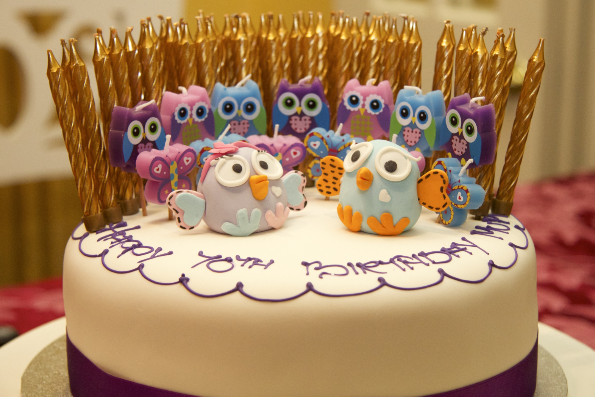 Owl-themed birthday candles in various colors