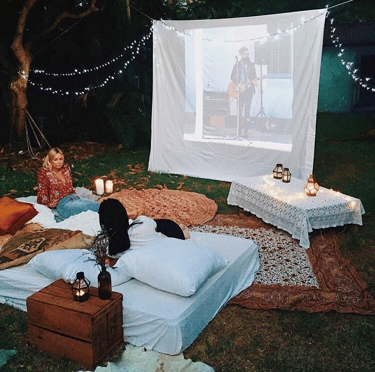 Outdoor pillows and blankets for a backyard movie night