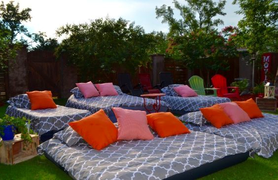 A backyard movie night with comfortable blankets and pillows