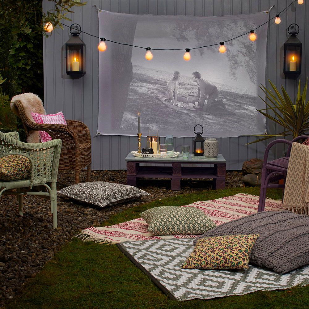 A backyard movie night with outdoor rugs for a rustic atmosphere