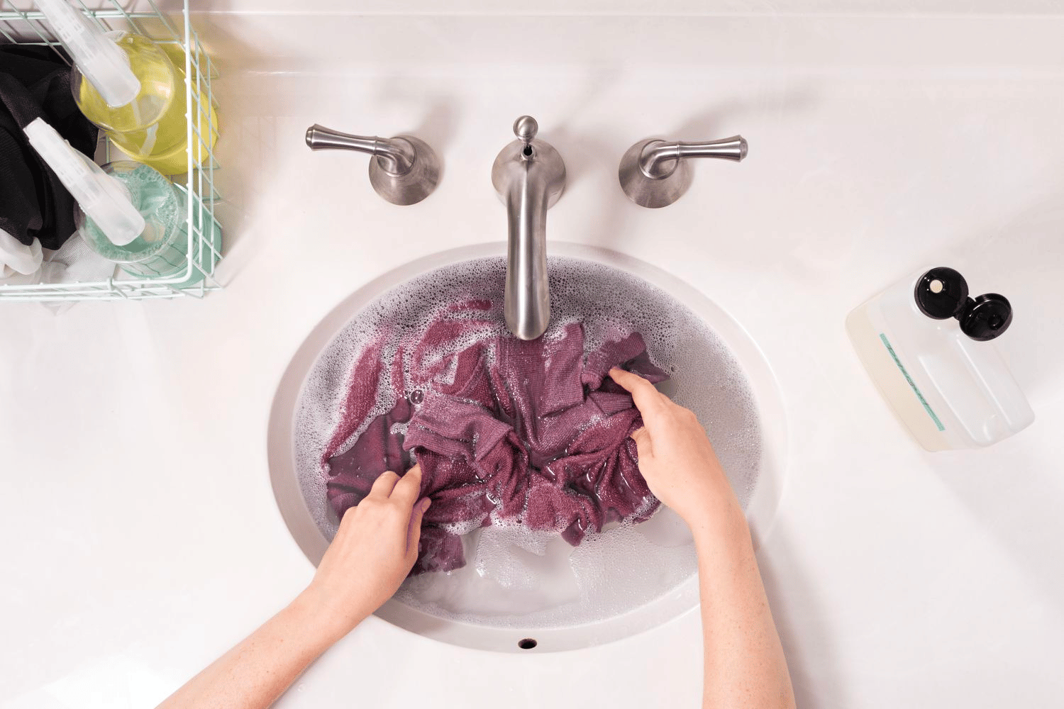 A shirt being washed in the sink