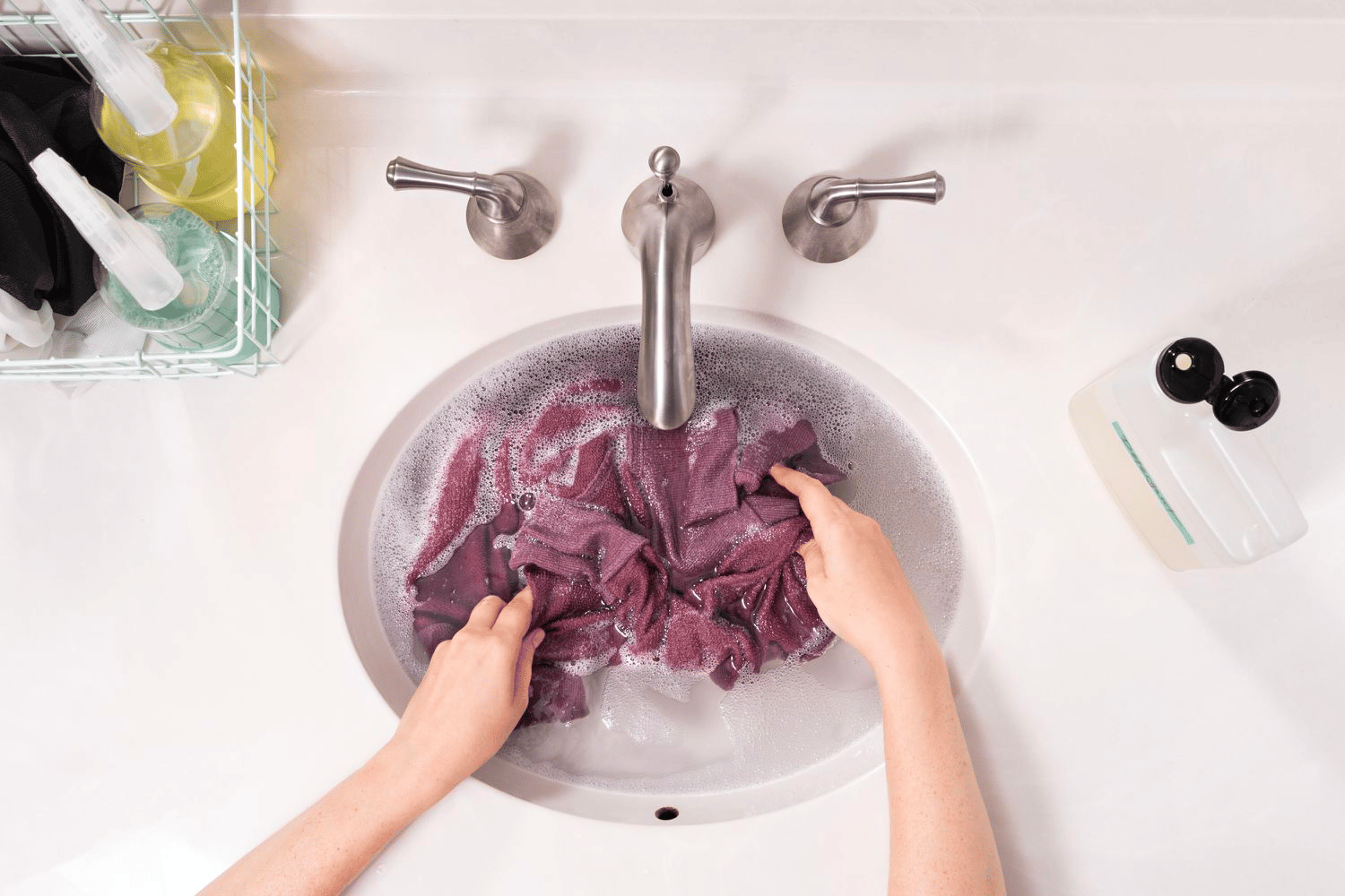 A shirt being washed in the sink A shirt being washed in the sink