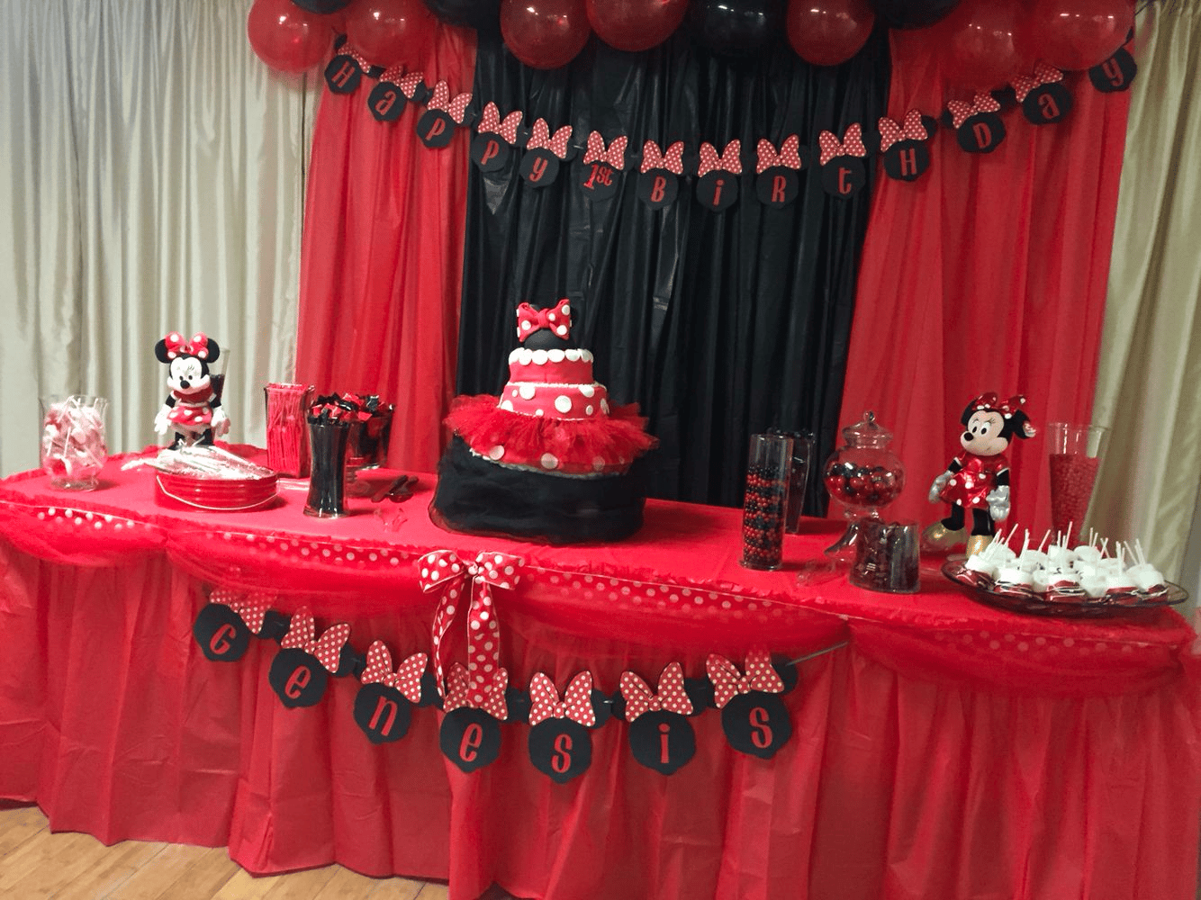 Minnie-mouse-themed party decor in pink, red, and black