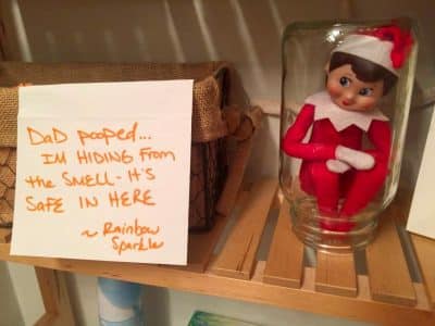 Mischievous elf on the shelf with a written note