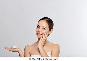 Lady moisturizing her skin Lady moisturizing her skin