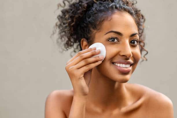 Image of a lady doing facial clean up Image of a lady doing facial clean up
