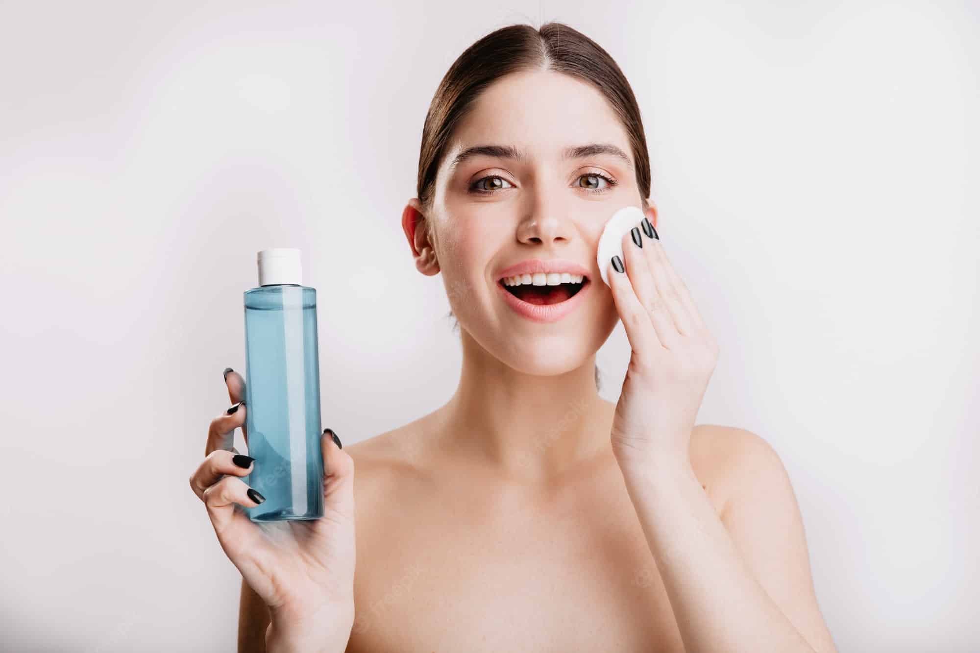 A lady applying face toner A lady applying face toner