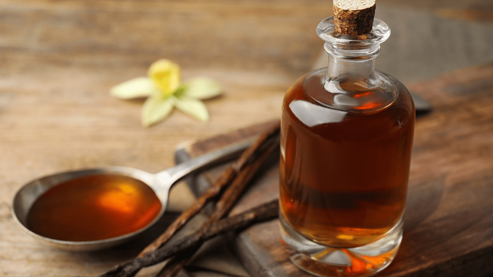 A jar and spoonful of vanilla extract A jar and spoonful of vanilla extract