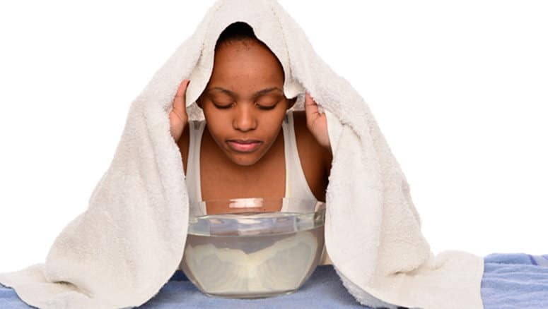 A lady is steaming her face A lady is steaming her face