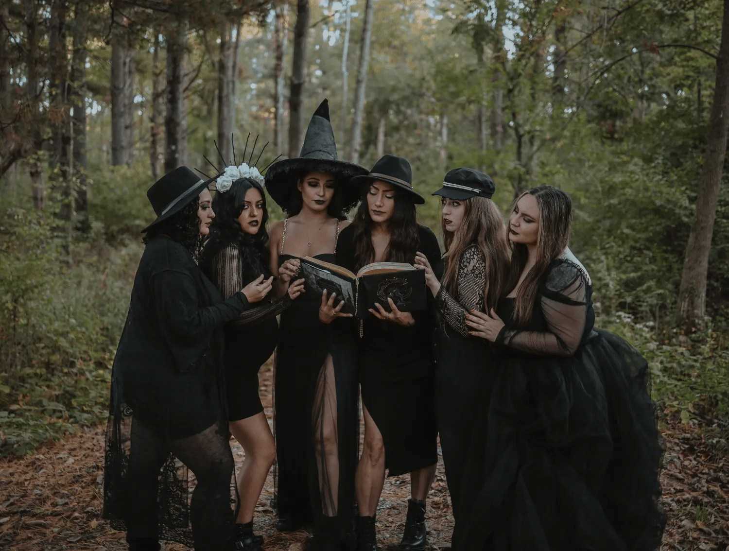 Halloween-themed photoshoot for friends in witch costumes
