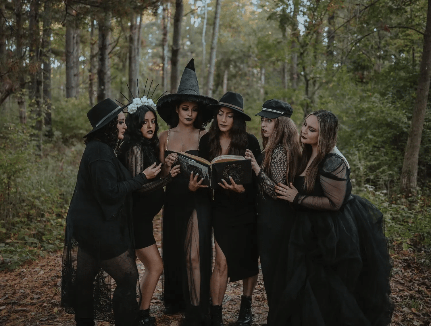 Halloween-themed photoshoot for friends in witch costumes Halloween-themed photoshoot for friends in witch costumes