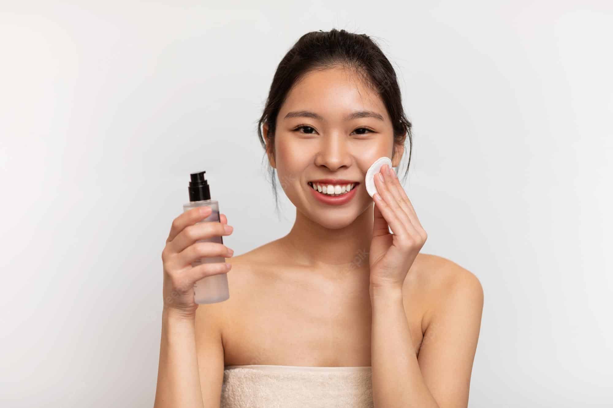 A lady cleaning her face A lady cleaning her face