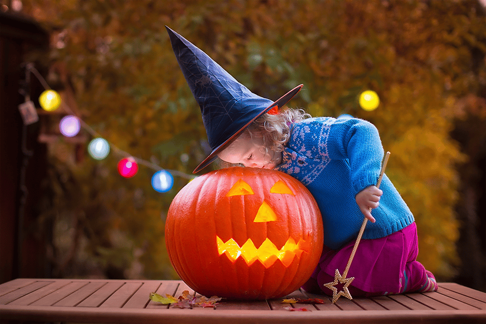 Halloween-themed photoshoot for a child in a witch costumes Halloween-themed photoshoot for a child in a witch costumes