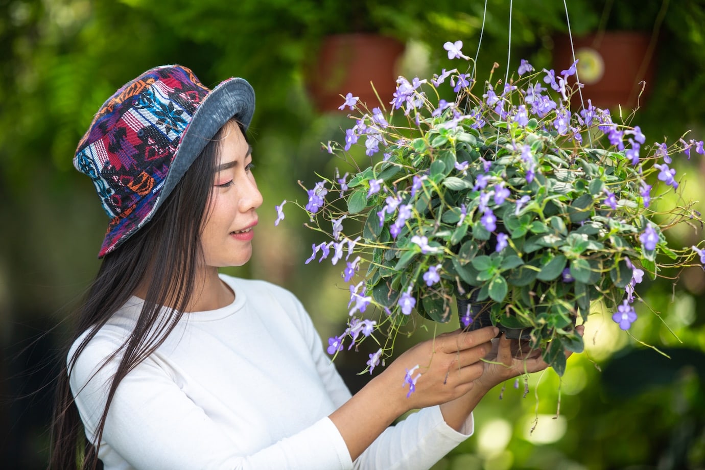 Girl admiring flower in garden